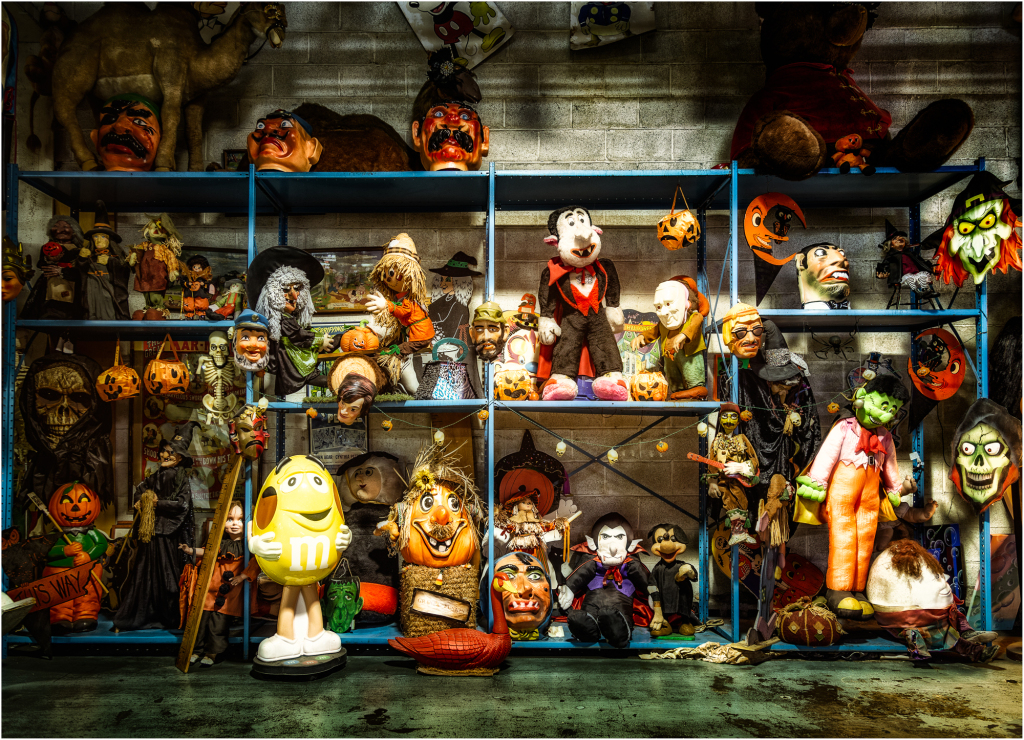 A haunting display of vintage Halloween puppets and masks.