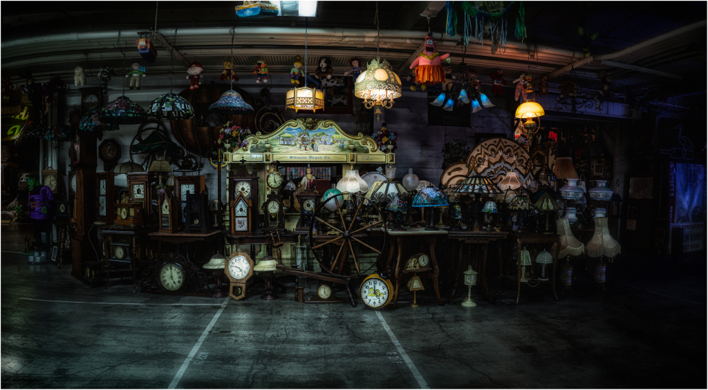 A dimly lit collection of vintage clocks and lamps, exuding a nostalgic charm.