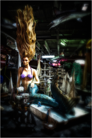 A haunting mermaid mannequin with flowing hair amidst eerie nautical decor.
