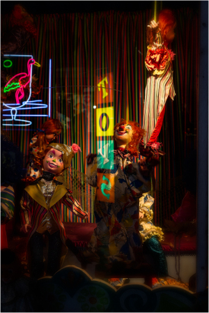 A vibrant display of clowns in a colorful, neon-lit setting.