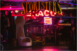 Neon-lit vintage garage filled with retro signs and memorabilia