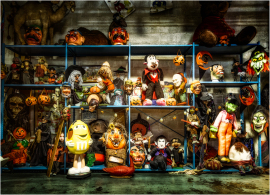 A haunting display of vintage Halloween puppets and masks.