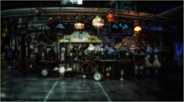 A dimly lit collection of vintage clocks and lamps, exuding a nostalgic charm.