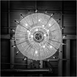 A stunning chandelier casts intricate shadows above.