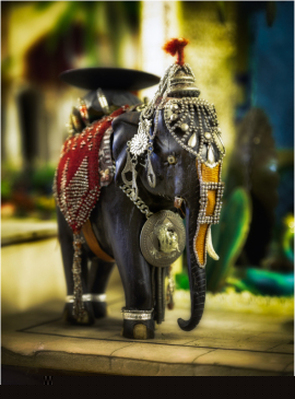 Ornate elephant figurine adorned with intricate details and vibrant colors.