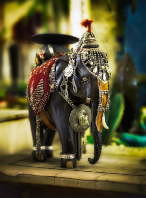 Ornate elephant figurine adorned with intricate details and vibrant colors.