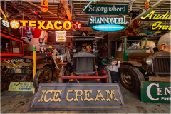 Vintage vehicles and neon signs create a nostalgic ambiance.