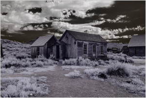 Historic wooden structures in a ghost town, showcasing early civic infrastructure.