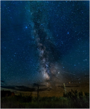 Starry night sky over a historic ghost town, revealing cosmic beauty.