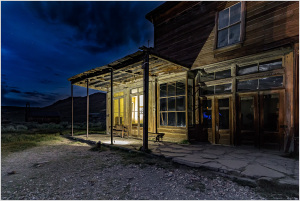 Historic building in Bodie, California, illuminated at night, showcasing its wooden structure.