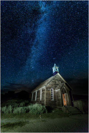 Historic wooden church under a starry sky in Bodie, California.
