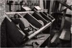 Rusty tools and equipment in an abandoned building, hinting at past infrastructure work.
