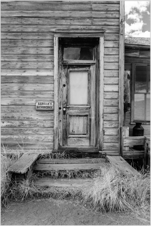 Weathered wooden door of a historic building in Bodie, California, showcasing rustic architecture.