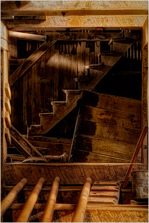 Wooden stairs and beams in a historic structure, showcasing hidden infrastructure.