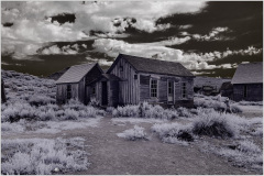 Historic wooden structures in a ghost town, showcasing early civic infrastructure.