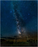Starry night sky over a historic ghost town, revealing cosmic beauty.