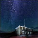 Historic building under a starry sky, showcasing civic architecture and infrastructure.