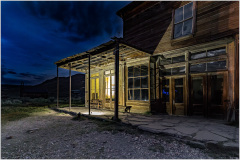 Historic building in Bodie, California, illuminated at night, showcasing its wooden structure.