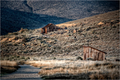 Abandoned wooden structures on a hillside in Bodie, California.