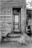 Weathered wooden door of a historic building in Bodie, California, showcasing rustic architecture.