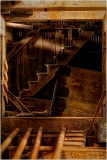 Wooden stairs and beams in a historic structure, showcasing hidden infrastructure.