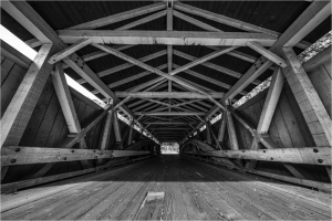 Interior view of a covered bridge showing wooden beams and structure