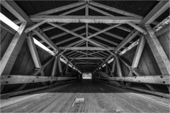 Interior view of a covered bridge showing wooden beams and structure