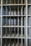 Gray shelving unit with multiple rectangular compartments, empty and organized