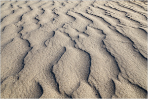 Rippling patterns of sand create a surreal landscape in Death Valley.
