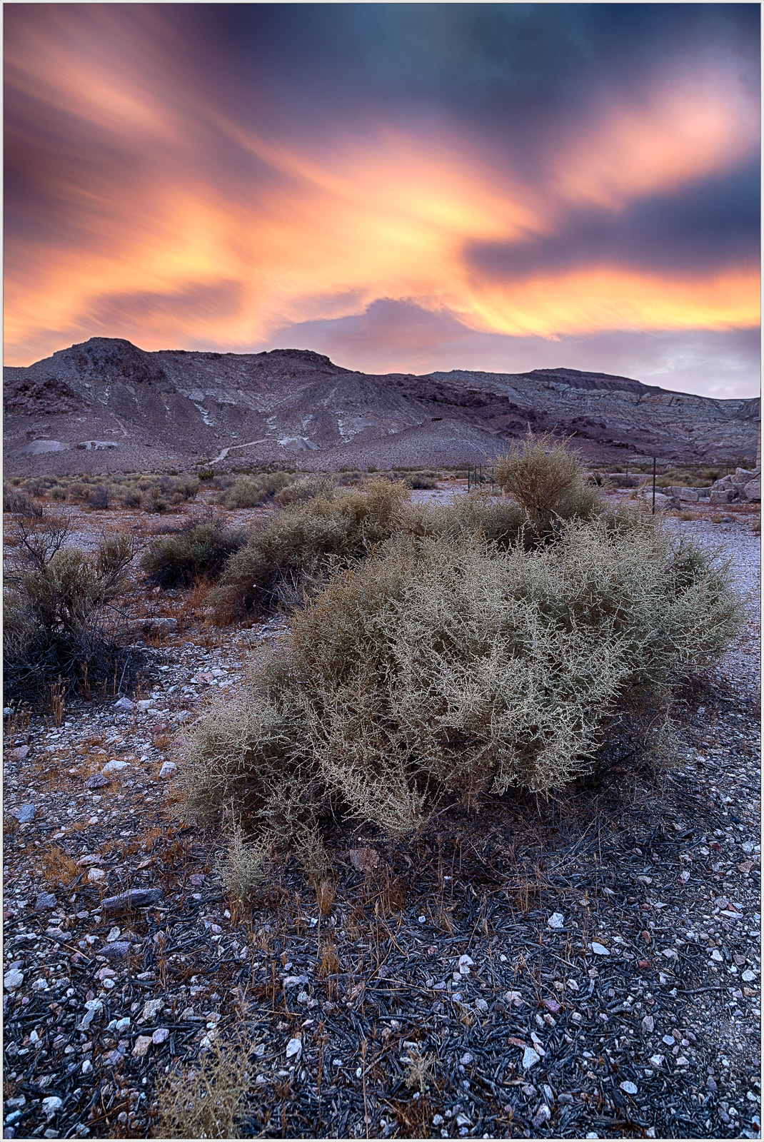 A surreal desert landscape with vibrant skies and rugged mountains.