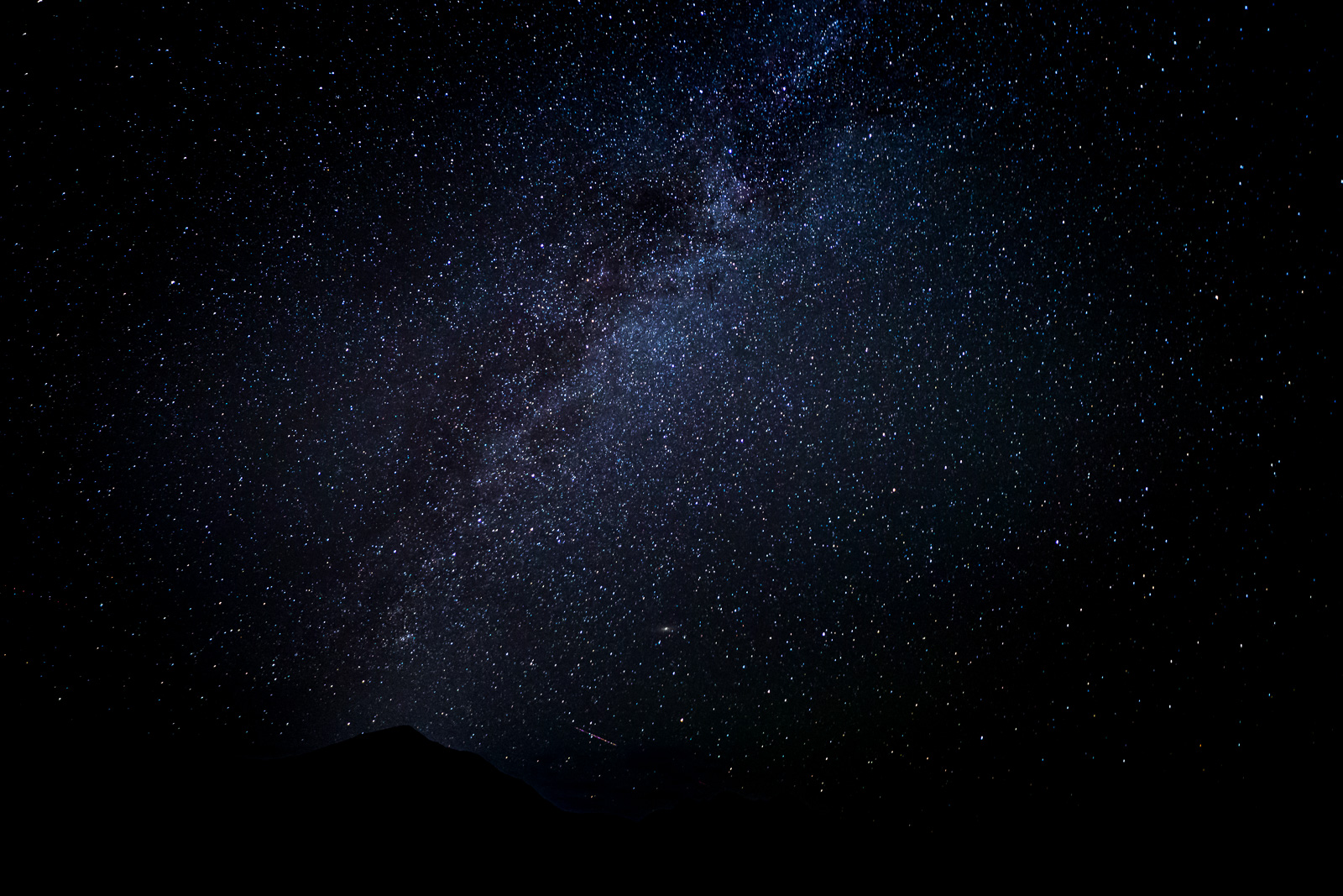 A vast night sky filled with countless stars and a hint of the Milky Way.