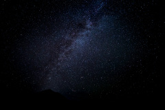 A vast night sky filled with countless stars and a hint of the Milky Way.