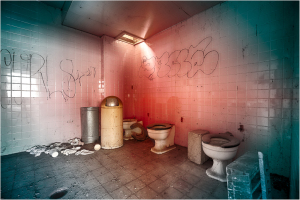 A surreal bathroom with vivid colors, shadows, and unexpected arrangements of objects.