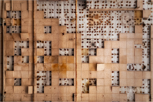 A surreal arrangement of irregular patterns and shadows in earth tones.