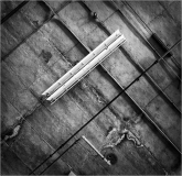 An overhead view of a textured surface with lines and a light fixture.