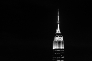 The Empire State Building illuminated against a dark night sky.
