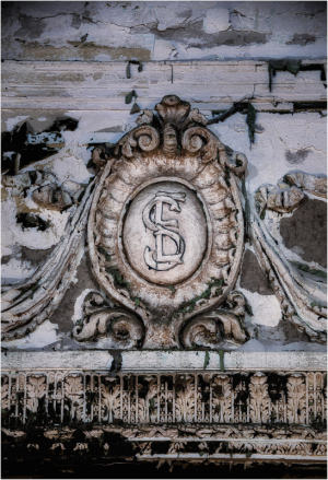 A weathered emblem with an intricate design, showing age and history.