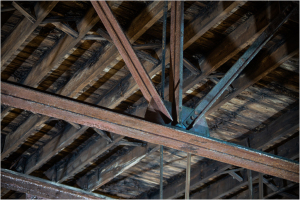 Intricate beams of wood create a dramatic overhead scene.