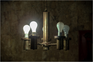 A vintage chandelier with glowing light bulbs, evoking a retro vibe.