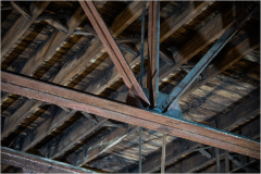 Intricate beams of wood create a dramatic overhead scene.