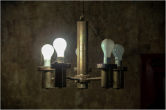 A vintage chandelier with glowing light bulbs, evoking a retro vibe.