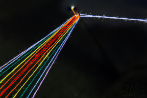 A close-up of a light beam splitting into vibrant rainbow colors.