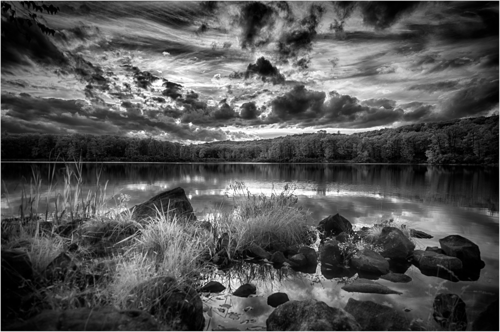A haunting lake scene shrouded in dark clouds