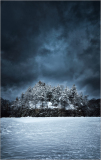 Snowy landscape under dark clouds, dramatic and icy.