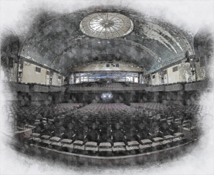 A grand theater interior with ornate architecture and empty seats under a domed ceiling.