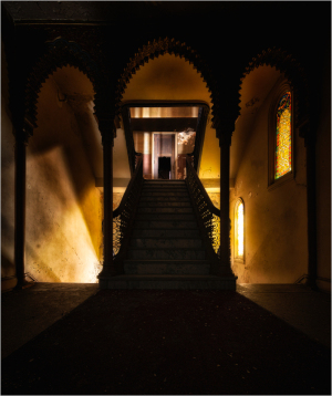 Interior of Irem Temple Theater featuring ornate arches and a staircase.