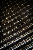A close-up of worn theater seats, faded and empty, echoes of past performances linger.