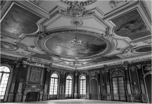 Elegant interior of a grand room with ornate ceiling and large windows