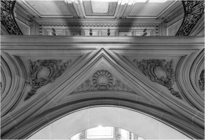 Architectural detail of an ornate archway with decorative elements in black and white.