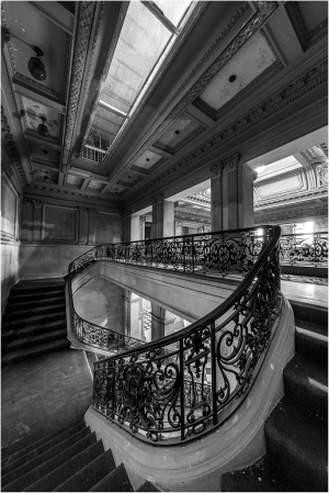 A grand staircase with ornate iron railing in a historic building.